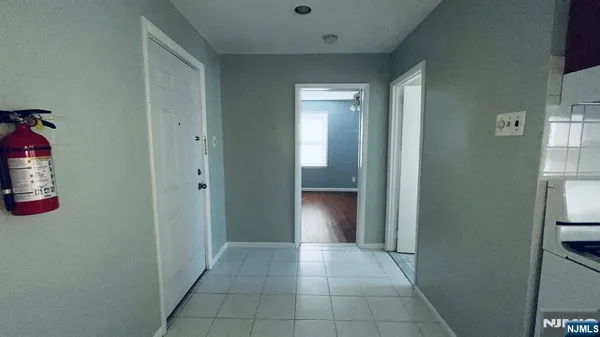 an entryway of a house and an empty room