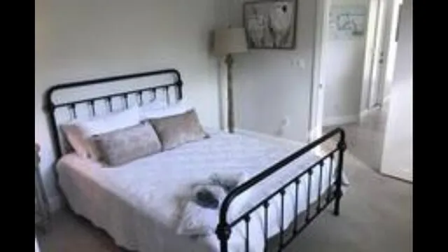 a bedroom with a bed next to a window