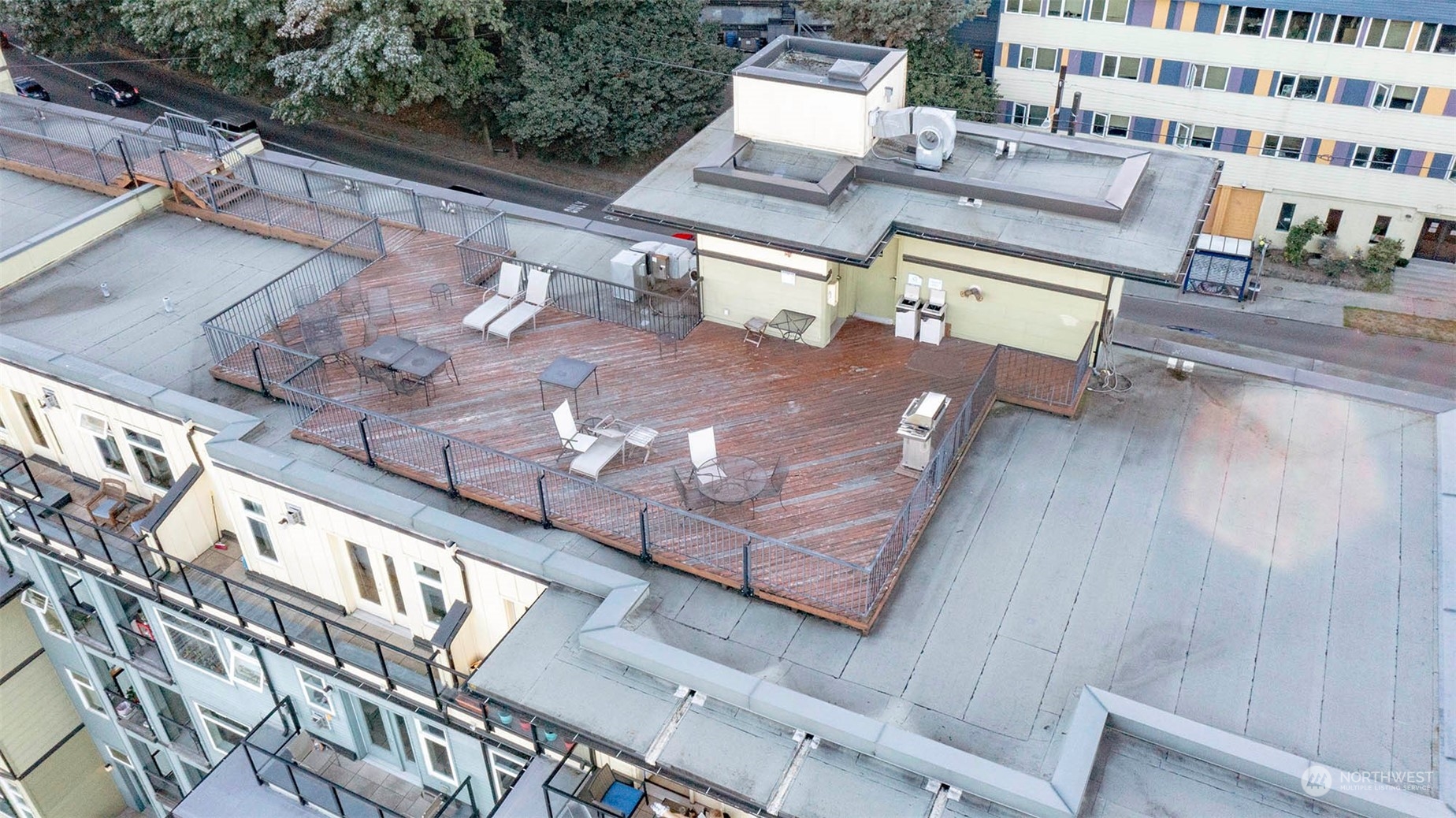 655 Crockett Street, Unit B304 Seattle, WA 98109 - Photo 24 of 35 a view of a patio with table and chairs and wooden floor