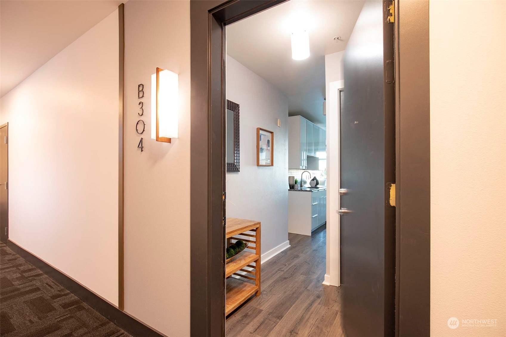 655 Crockett Street, Unit B304 Seattle, WA 98109 - Photo 3 of 35 a view of a hallway with bathroom and wooden floor