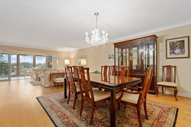 1 North Dee Road, Unit 2D Park Ridge, IL 60068 - Photo 11 of 38 a dining room with furniture a chandelier and wooden floor