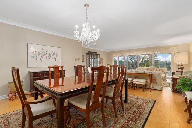 1 North Dee Road, Unit 2D Park Ridge, IL 60068 - Photo 12 of 38 a dining room with furniture a chandelier and wooden floor