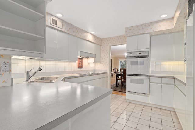 1 North Dee Road, Unit 2D Park Ridge, IL 60068 - Photo 16 of 38 a kitchen with a refrigerator and white cabinets