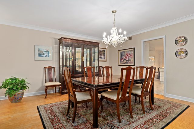 1 North Dee Road, Unit 2D Park Ridge, IL 60068 - Photo 10 of 38 a view of a dining room with furniture window and wooden floor