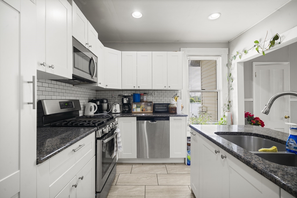 3 Cleveland Street Springfield, MA 01104 - Photo 5 of 14 a kitchen with stainless steel appliances granite countertop a sink stove and cabinets