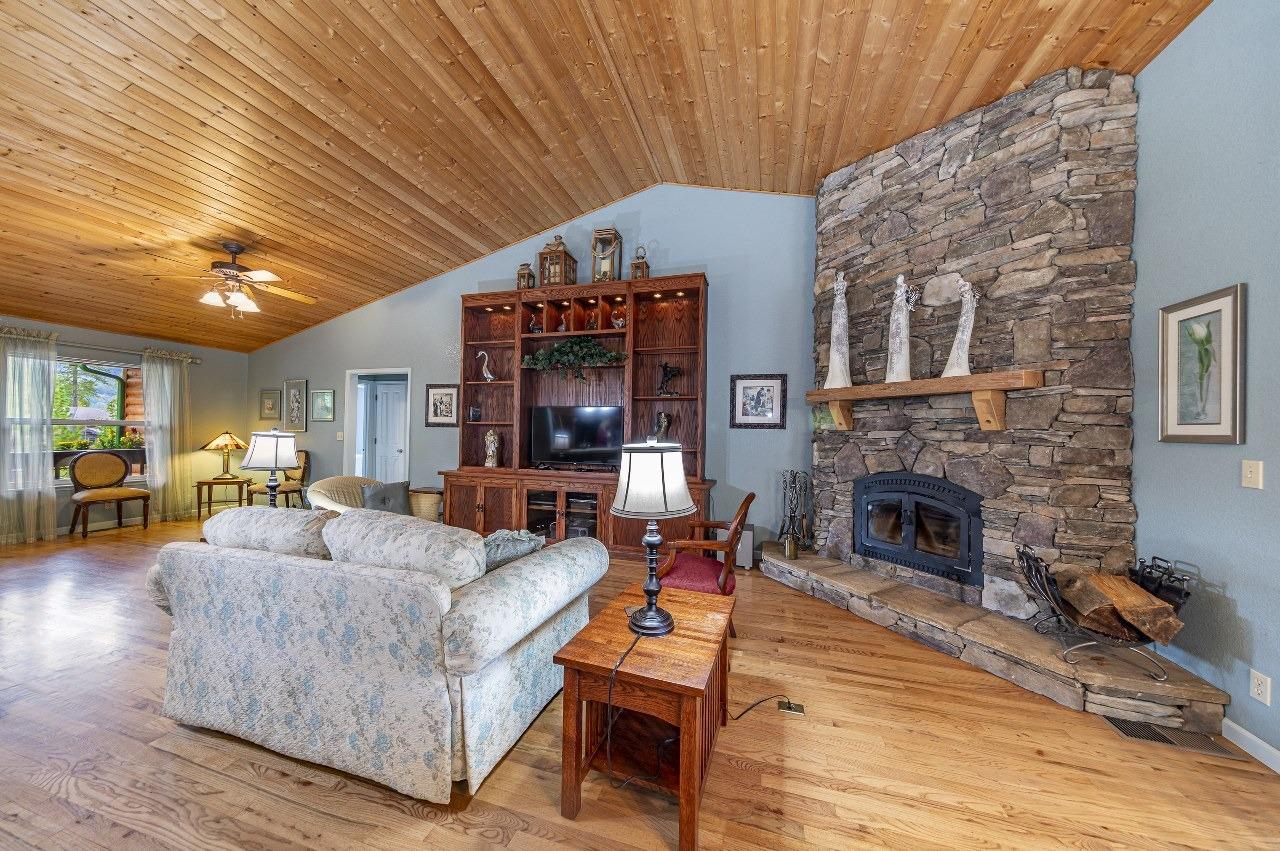 53312 Timberview Road North Fork, CA 93643 - Photo 12 of 84 a living room with furniture a fireplace and a table