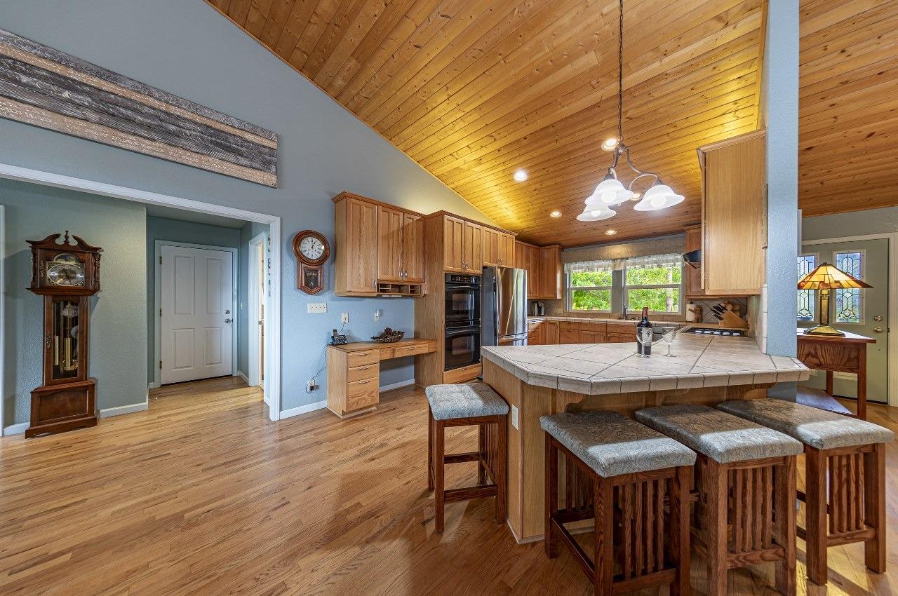 53312 Timberview Road North Fork, CA 93643 - Photo 19 of 84 a dining hall with stainless steel appliances kitchen island a table and chairs in it