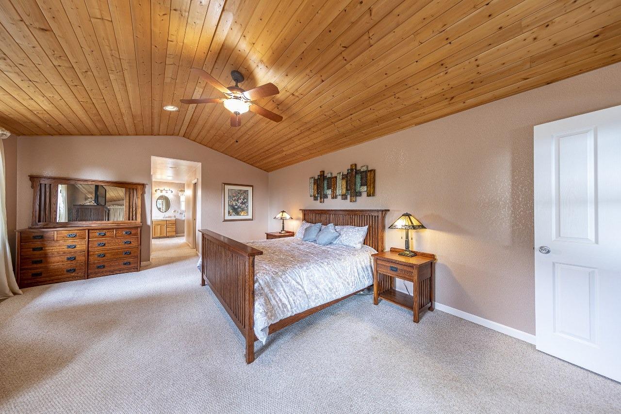 53312 Timberview Road North Fork, CA 93643 - Photo 36 of 84 a living room with a bed furniture a chandelier and closet
