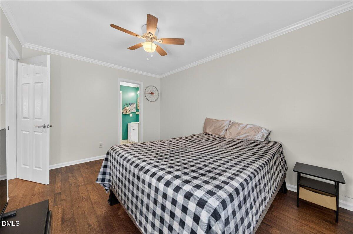 503 Gooseneck Drive, Unit A1 Cary, NC 27513 - Photo 14 of 37 a bedroom with a bed and wooden floor