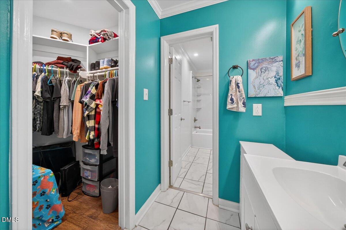 503 Gooseneck Drive, Unit A1 Cary, NC 27513 - Photo 18 of 37 a view of walk in closet with clothes and shoes