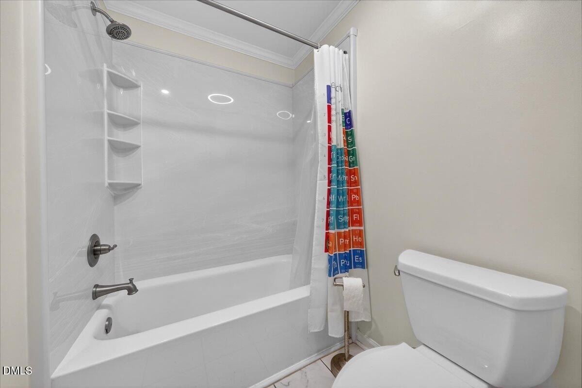 503 Gooseneck Drive, Unit A1 Cary, NC 27513 - Photo 19 of 37 a bathroom with a toilet and a bathtub