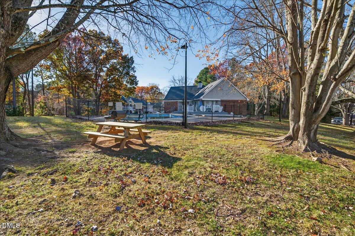 503 Gooseneck Drive, Unit A1 Cary, NC 27513 - Photo 31 of 37 a swimming pool with outdoor seating and yard