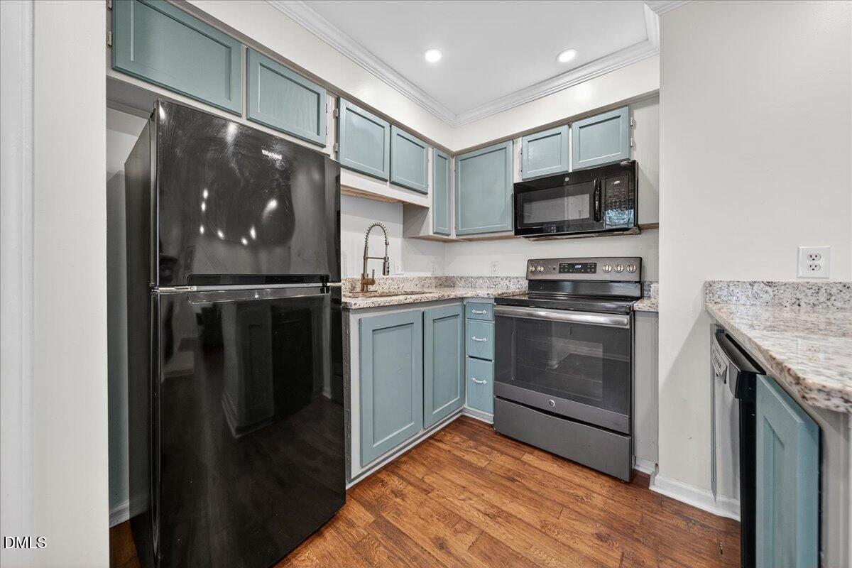 503 Gooseneck Drive, Unit A1 Cary, NC 27513 - Photo 9 of 37 a kitchen with stainless steel appliances granite countertop a stove top oven and sink