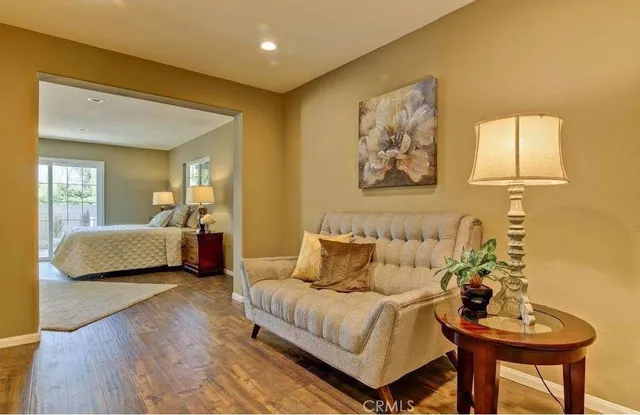 a bathroom with a granite countertop sink a mirror a window and a bathtub