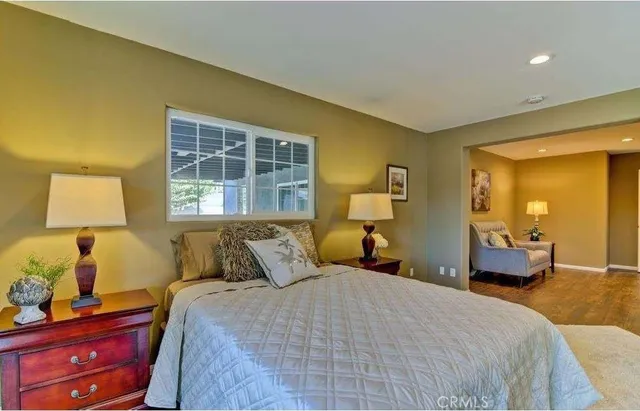 a bedroom with a bed and a chair