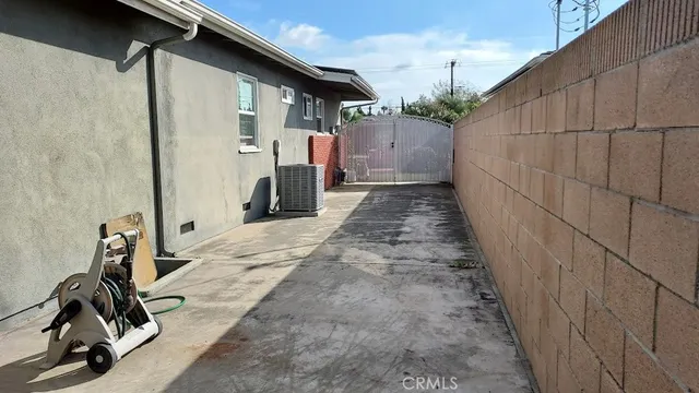 a view of house with backyard and sitting area