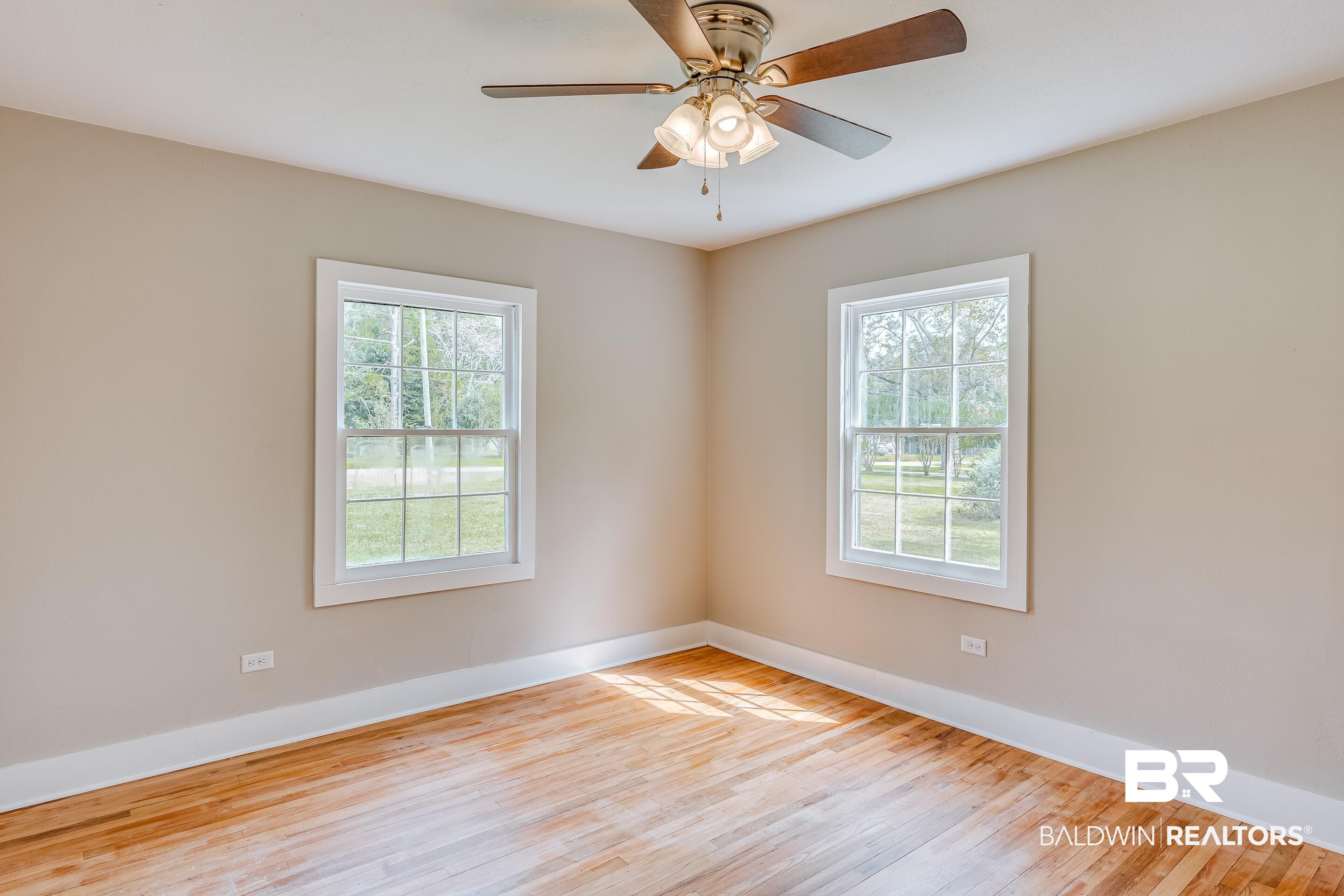 8001 16th Street Irvington, AL 36544 - Photo 20 of 35 Empty room featuring light wood finished floors and healthy amount of natural light