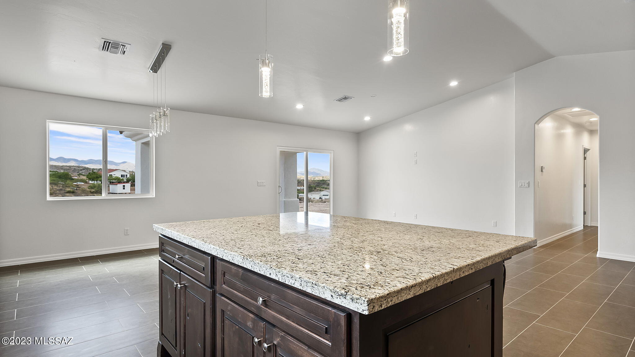 1019 Paseo Guebabi Rio Rico, AZ 85648 - Photo 16 of 25 a kitchen with kitchen island a counter top space and a sink