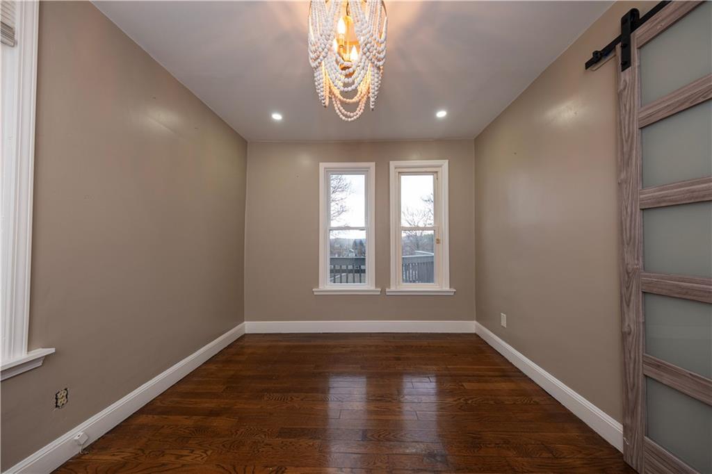 979 Seventh Street Beaver, PA 15009 - Photo 20 of 47 a view of an empty room with wooden floor and a window