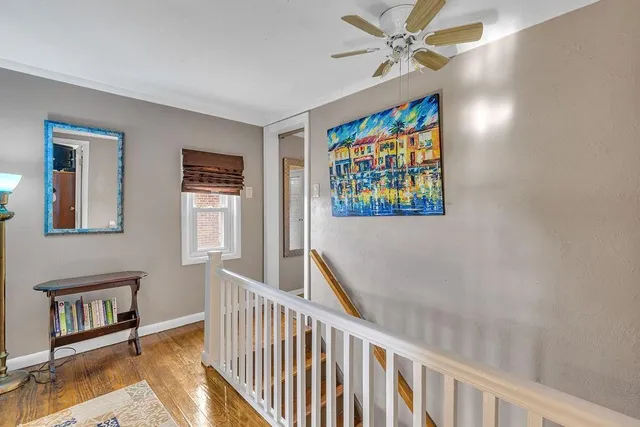 a view of a hallway with wooden floor and entryway