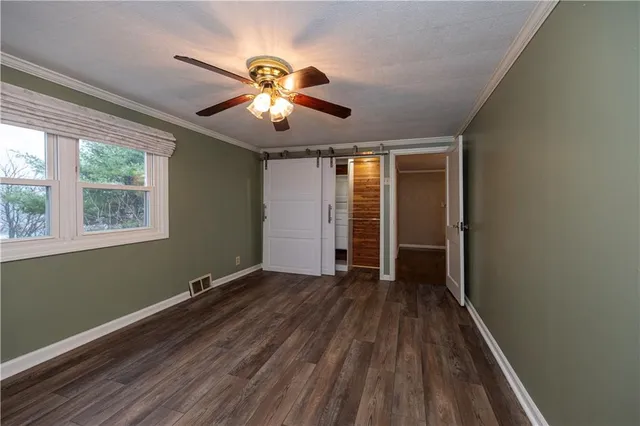 a view of a room with wooden floor and windows
