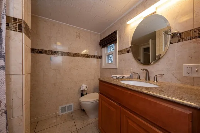 a view of a deck with couches table and chairs with wooden floor