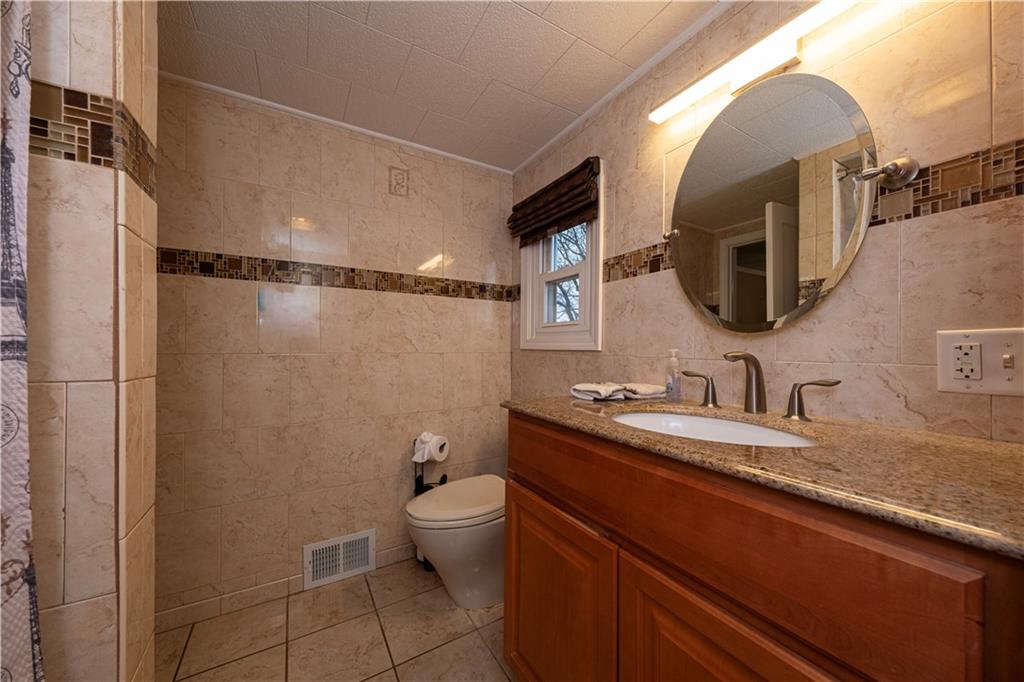 979 Seventh Street Beaver, PA 15009 - Photo 35 of 47 a bathroom with a granite countertop sink mirror and toilet