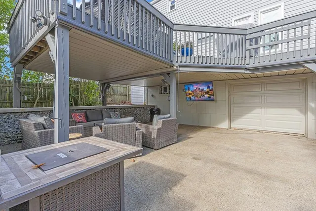 a view of a patio with table and chairs potted plants with wooden fence