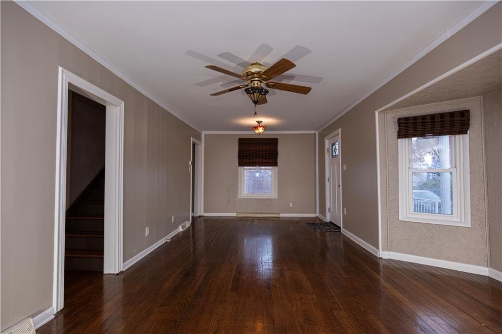 979 Seventh Street Beaver, PA 15009 - Photo 7 of 47 a view of a livingroom with wooden floor a ceiling fan and windows