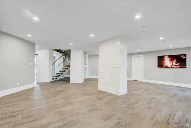 a bathroom with a granite countertop sink a toilet a mirror and shower