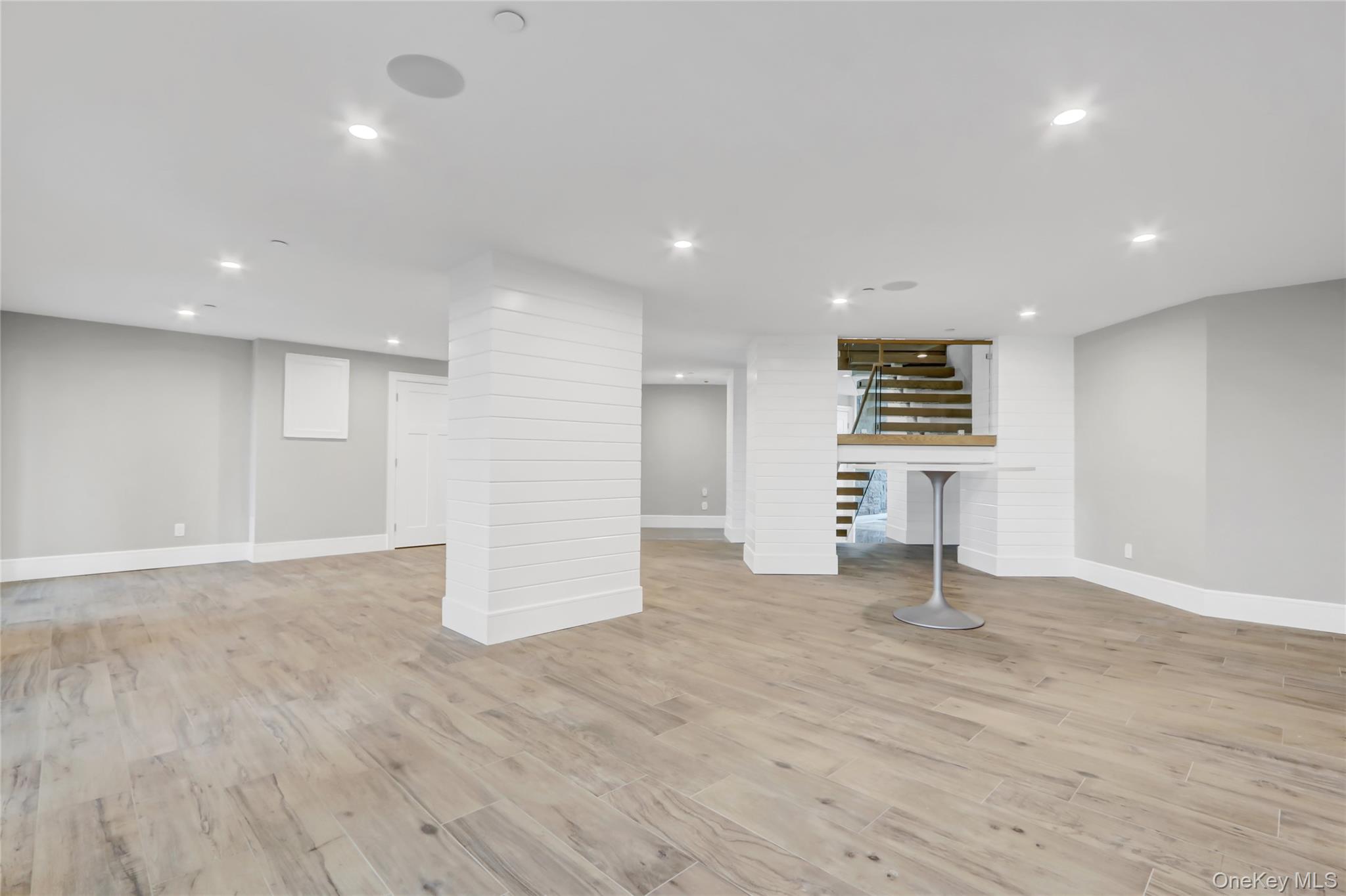 44 Bayside Drive Point Lookout, NY 11569 - Photo 18 of 47 Finished ground level area with recessed lighting, light wood-style floors, and stairway