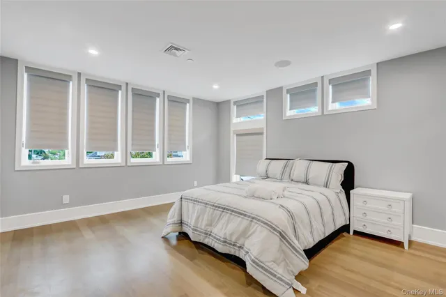 a large white kitchen with a large island in the center