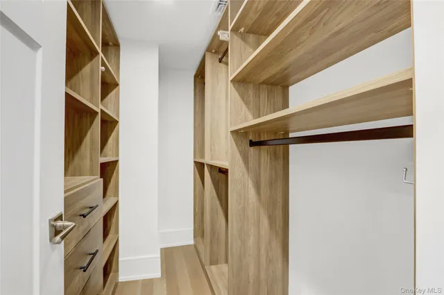a large kitchen with lots of counter space and chairs