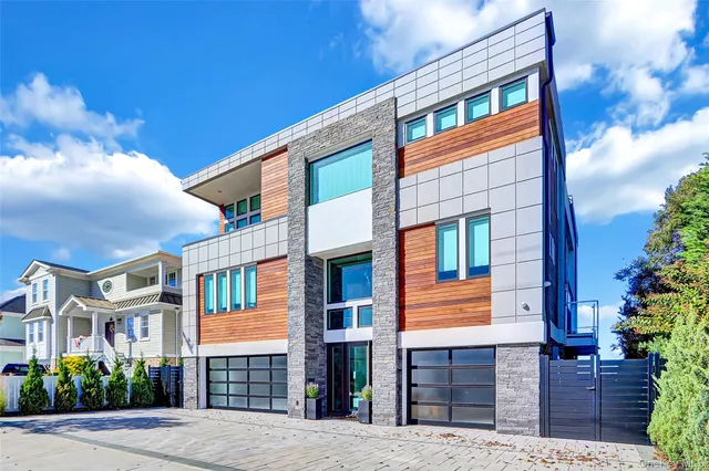 a front view of a house with plants