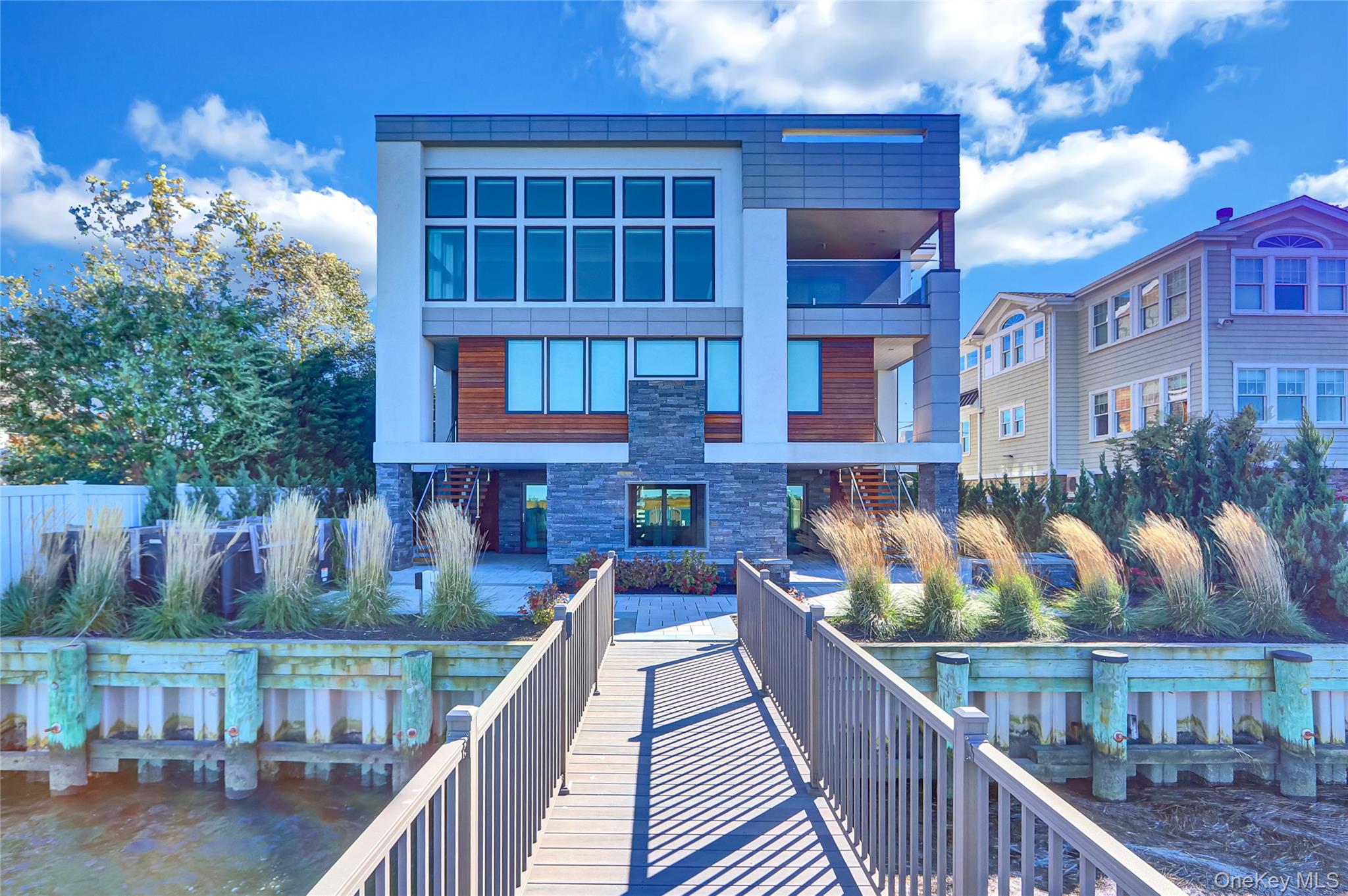 44 Bayside Drive Point Lookout, NY 11569 - Photo 4 of 47 Back of house featuring stone siding and stucco siding