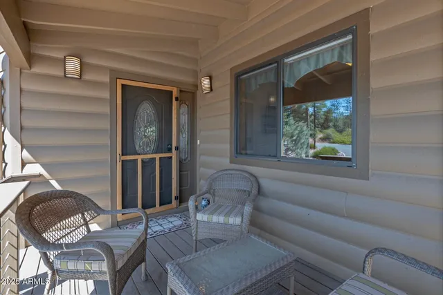 a living room with furniture fireplace and a large window