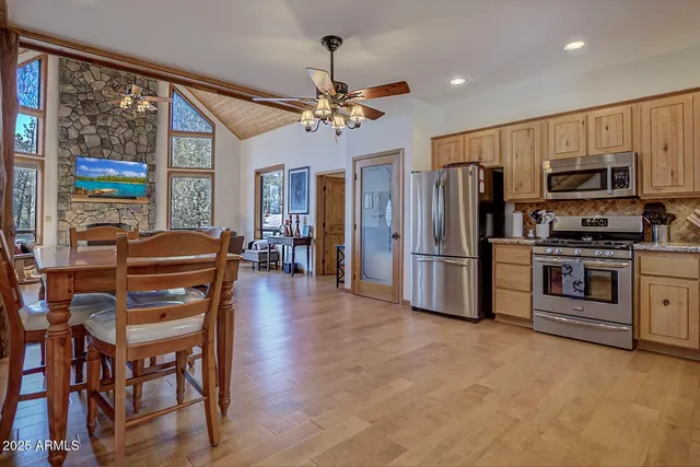 a kitchen with granite countertop stainless steel appliances cabinets a window and a sink