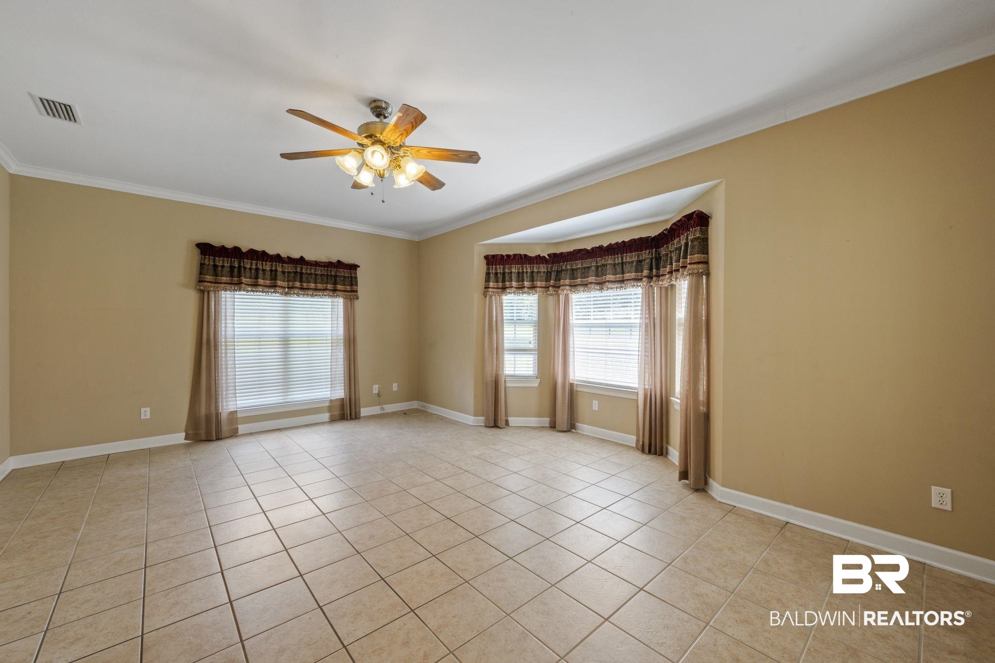 5618 Leytham Road Theodore, AL 36582 - Photo 26 of 60 Empty room featuring ceiling fan, ornamental molding, and light tile patterned floors