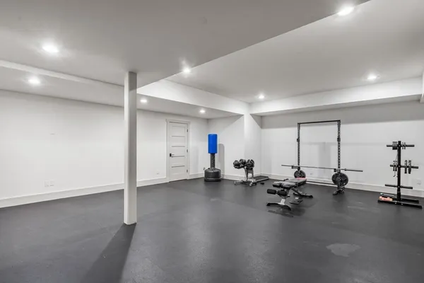 a view of a room with gym equipment and a large window
