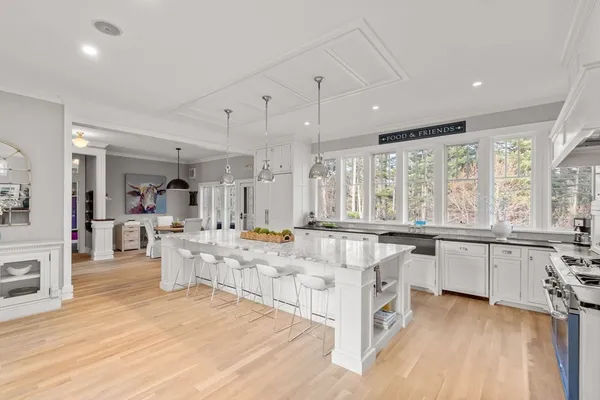 a large white kitchen with a large window