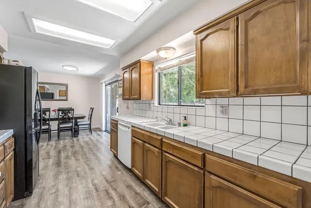 a kitchen with a sink cabinets and window