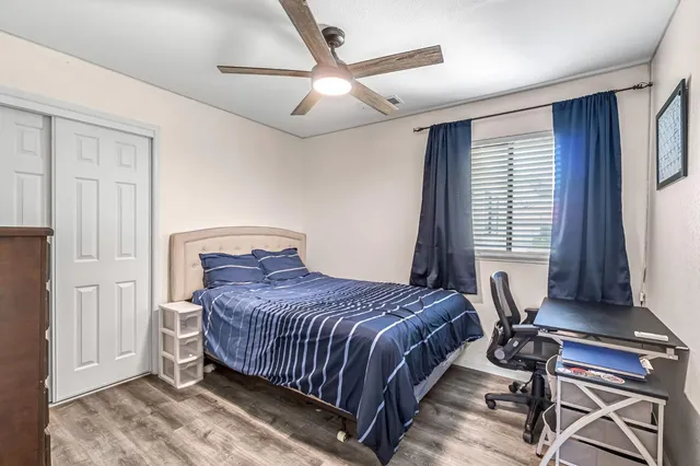 a bathroom with a granite countertop toilet sink and mirror
