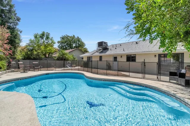 a view of a swimming pool with a yard