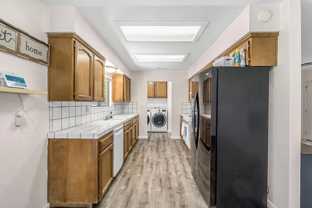 a kitchen with a refrigerator a sink and dishwasher