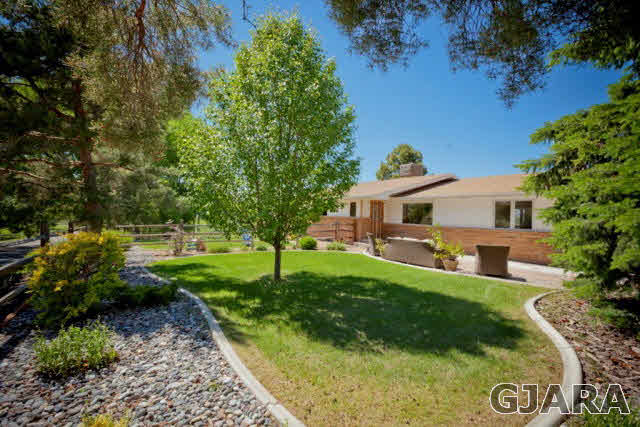 2638 H Road Grand Junction, CO 81506 - Photo 1 of 36 a front view of a house with garden