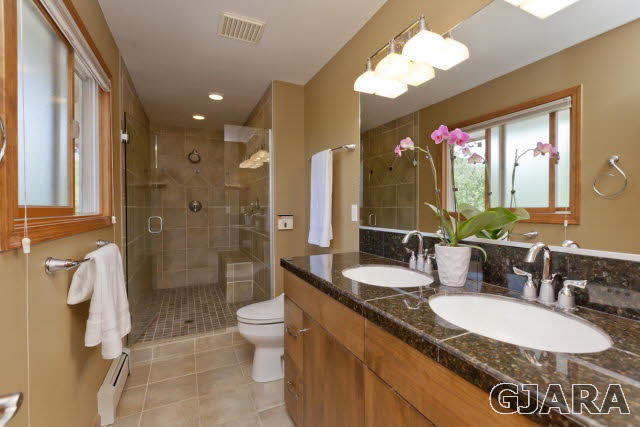 2638 H Road Grand Junction, CO 81506 - Photo 17 of 36 a bathroom with a granite countertop double vanity sink mirror shower and a toilet