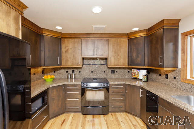 2638 H Road Grand Junction, CO 81506 - Photo 10 of 36 a kitchen with kitchen island granite countertop a sink stainless steel appliances and cabinets