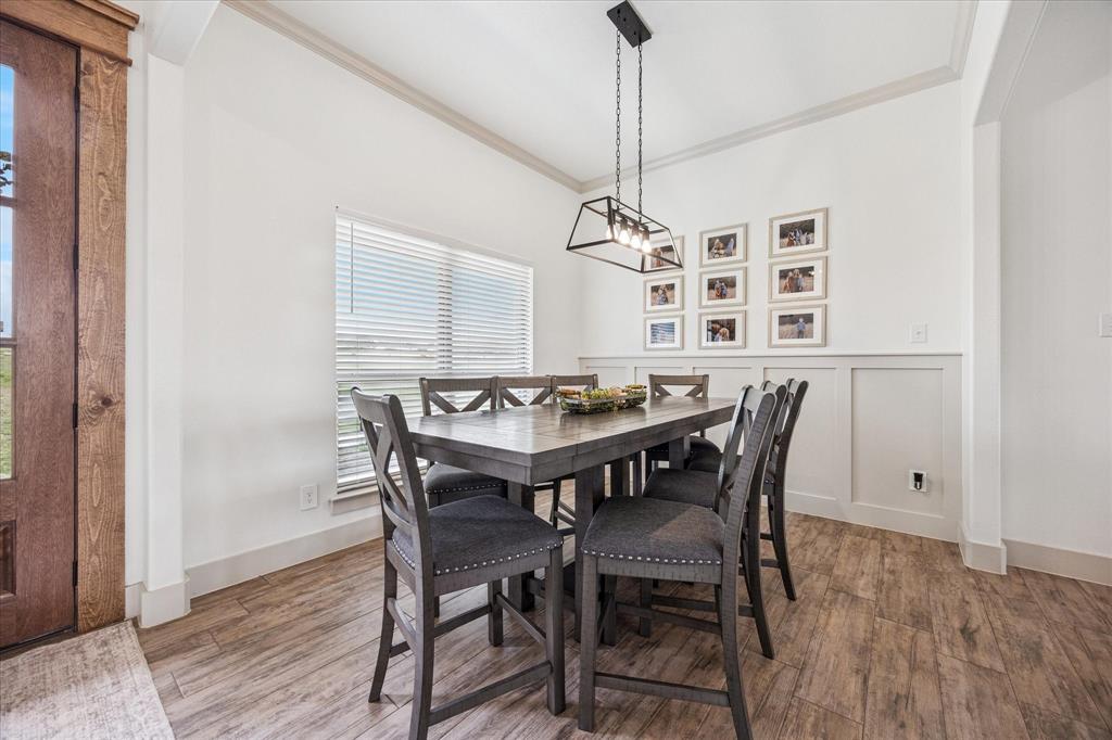 2028 Carrie Court Weatherford, TX 76088 - Photo 11 of 40 a view of a dining room with furniture window and wooden floor