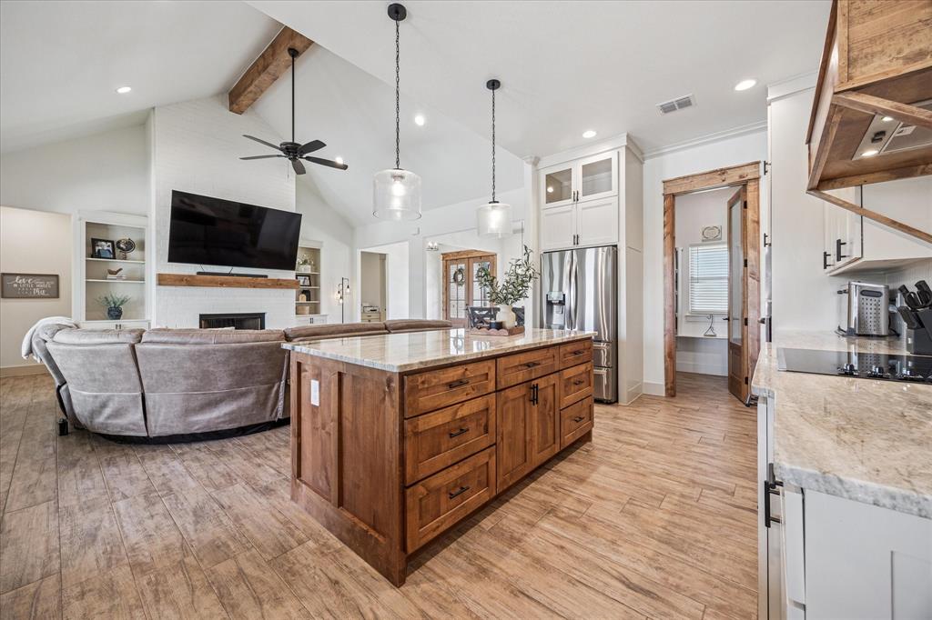 2028 Carrie Court Weatherford, TX 76088 - Photo 12 of 40 a living room with furniture and a flat screen tv