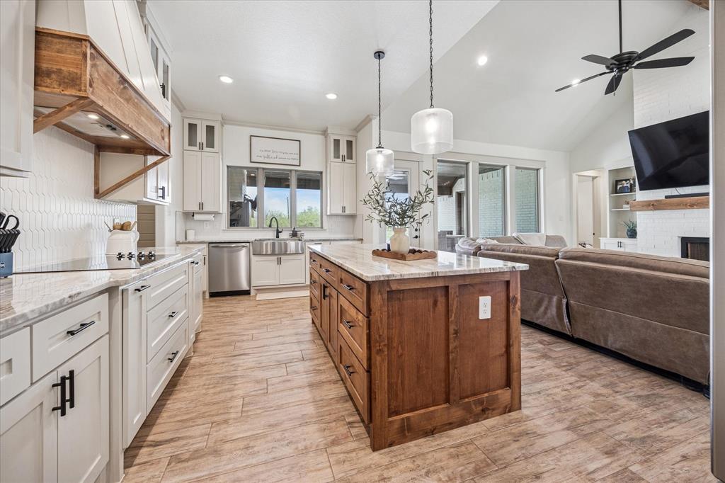 2028 Carrie Court Weatherford, TX 76088 - Photo 40 of 40 a large kitchen with a large counter space cabinets and stainless steel appliances